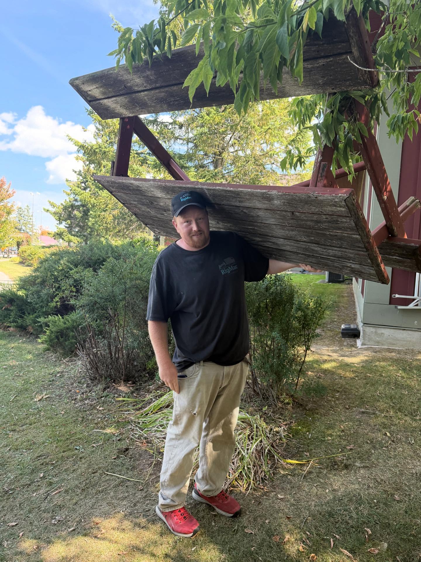 RigMac team member hauling away a junk table